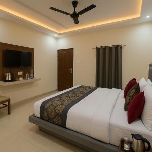 a bedroom with a large bed with red pillows at IQ Hotels - Luxury Stay Near Ram Mandir in Ayodhya