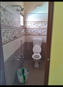 a small bathroom with a toilet and a shower at LAKSH COTT Home Stay in Arumuganeri