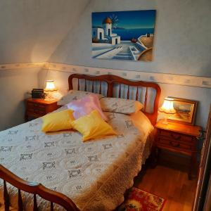 a bedroom with a bed with two lamps on it at Courseulles Comme À La Maison in Courseulles-sur-Mer