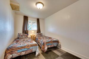 a bedroom with two beds and a window at Fish and Hike! Home Base for Kachemak Bay Adventures in Homer