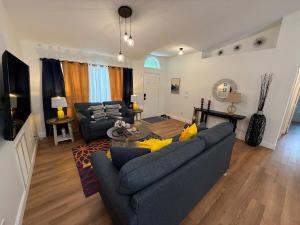 a living room with a blue couch and a table at The Beach House in Port Saint Lucie