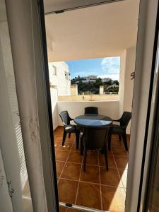a balcony with a table and chairs in a room at Spirit of Mojacar Playa Resort in Mojácar