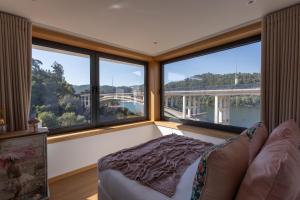 a living room with large windows and a couch at Estrelas do Douro in Gondomar