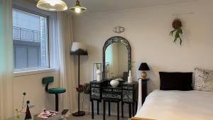 a bedroom with a bed and a dressing table with a mirror at Secret Villa Seoul , Korean Traditional and morden mix Design in Seoul