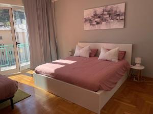 a bedroom with a large bed with a large window at La Maison V in Pontebba