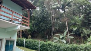 a view of the garden from the outside of a house at Estúdio Raiz da Mata in Nova Friburgo