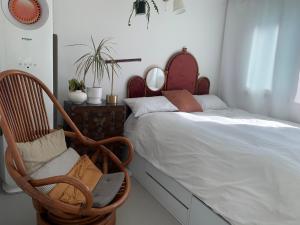 a bedroom with a bed and a rocking chair at Secret Villa Seoul , Korean Traditional and morden mix Design in Seoul