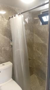 a bathroom with a shower curtain and a toilet at Ani guest house in Meghri +25 photos