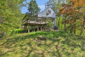 a house on top of a hill in the woods at House Under The Cliff in New Paltz