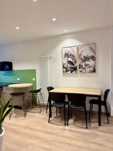 a meeting room with tables and chairs and paintings on the wall at Mezzaterra 40 - Nel cuore del centro storico in Belluno