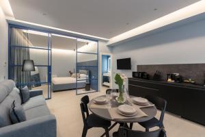 a living room with a couch and a table with chairs at Casa Foligno by Hili in Rome