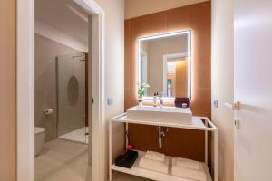 a bathroom with a sink and a mirror at Casa Foligno by Hili in Rome +64 photos