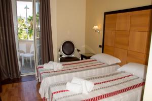Katil atau katil-katil dalam bilik di Regent Beachotel