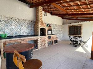 a patio with a brick oven and a table and chairs at Chácara vó Zenilda in Itatiaia