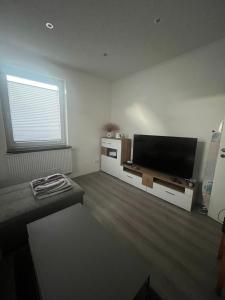 a living room with a flat screen tv on a wall at Sunshine in Groß-Zimmern