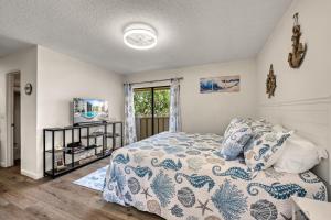 a bedroom with a bed and a window at Coastal Condo, Water Views, Fishing Dock & 0.6 Miles to Siesta Beach in Siesta Key +53 photos