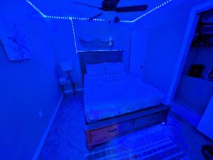 a bedroom with a bed with a ceiling fan at 2 Minute Walk to Beach & Downtown! in Cocoa Beach +26 photos