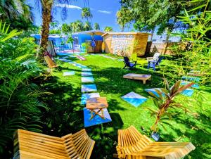 a yard with two chairs and a table and benches at 2 Minute Walk to Beach & Downtown! in Cocoa Beach