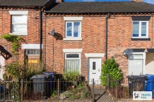 a brick house with white doors and a fence at Rocester Rest close to Alton Towers & JCB, Netflix in Rocester