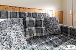 a couch with pillows on top of it at Rocester Rest close to Alton Towers & JCB, Netflix in Rocester