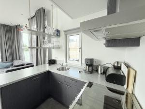a kitchen with a sink and a counter top at De Maasterp - Woonboot 5 in Montfort