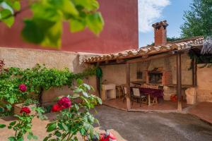 an outdoor patio of a house with a fireplace at Apartamentos Casa La Cuca in Alfambra +18 photos