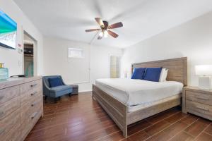 a bedroom with a bed and a ceiling fan at Sea Club II By Beachside Management in Siesta Key +34 photos