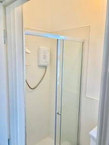 a shower with a glass door in a bathroom at 1 Bed Flat - Sleeps 2 - Pets - Parking - Garden in Eglinton