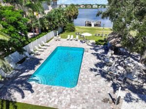 an overhead view of a swimming pool with chairs and water at Sea Club II By Beachside Management in Siesta Key