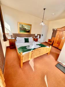 a bedroom with a large wooden bed in a room at Hotel Elisabeth Ilse in Braunlage