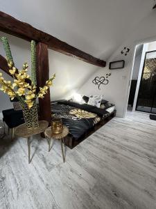 a bedroom with a bed and a vase of flowers at Statek Březina 