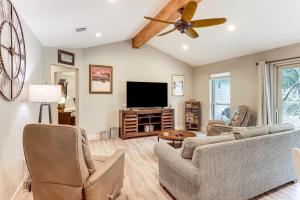 a living room with a couch and a flat screen tv at Gorgeous San Marco Home with Patio and Grill! in San Marcos