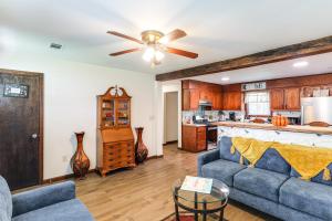 a living room with a couch and a kitchen at Game Day Getaway! Home with Yard, 4 Mi to Ole Miss in Oxford