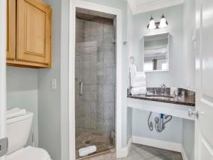 a bathroom with a shower and a toilet and a sink at Serenity Eden in Perdido Key