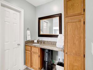 a bathroom with a sink and a mirror at Serenity Eden in Perdido Key +28 photos