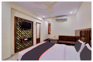 Camera con letto, TV e divano. di Hotel Moonlight Palace Near Patia Railway Station-Fully Air Conditioning Hotel - Luxury & Spacious Room -A Premium Hotel a Cuttack