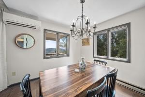 a dining room with a wooden table and chairs at Mountain Sunrise in Blowing Rock
