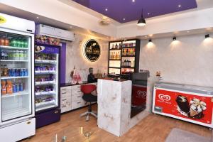 a coca cola shop with a counter and a soda at Hotel Hill View in Guwahati +11 photos