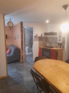 a living room with a table and a kitchen at Iziomi in La Tour-dʼAuvergne +2 photos