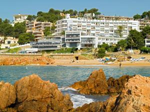 a view of a beach and a building at Gran Hotel Reymar in Tossa de Mar