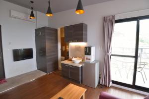 a kitchen with a refrigerator and a table and a window at Blue Sky B&B in Jiufen