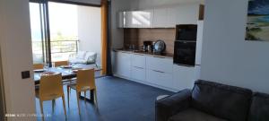 a kitchen and dining room with a table and chairs at La Goelette in Vieux-Fort