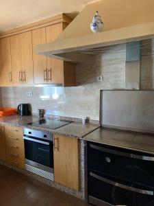 a kitchen with a stove and a stove top oven at Pomares Country House in Melgaço +15 photos