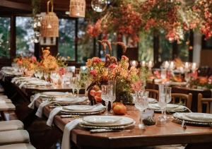 a long table with plates and glasses on it at Hotel Fazenda Bela Vista in Dourado +91 photos