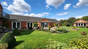 a house with a yard with green grass at Aberfall Private Luxury Villa Indoor Pool Hot Tub Gym Cinema in Goxhill