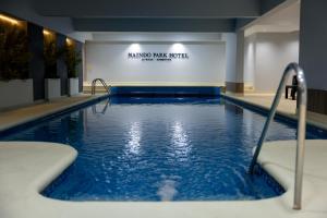 a large swimming pool with blue water in a building at Naindo Park Hotel in La Rioja