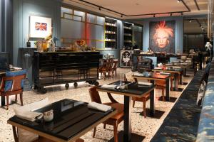 a restaurant with tables and a bar with a piano at The Glam Boutique Hotel & Apt in Vicenza