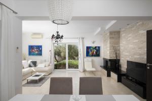 a living room with a couch and a table at Villa Mason with Heated Pool and mini Wellness in Rovinjsko Selo