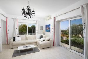 a living room with a couch and a table at Villa Mason with Heated Pool and mini Wellness in Rovinjsko Selo