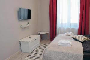 a bedroom with a bed and a tv on the wall at HOGOR Apartments in Sibiu